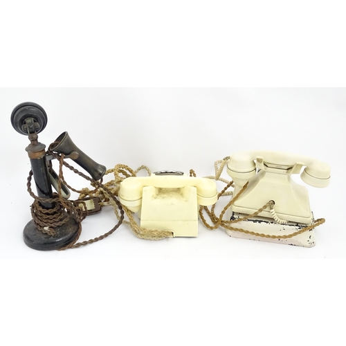 1547 - Four assorted mid 20thC GPO telephones, 
together with a candlestick telephone, the largest approx 1... 