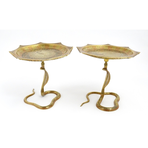 1548 - A pair of Benares brass tazzas with cobra / snake supports, the tops with stylised peacock detail an... 