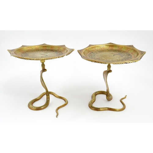 1548 - A pair of Benares brass tazzas with cobra / snake supports, the tops with stylised peacock detail an... 