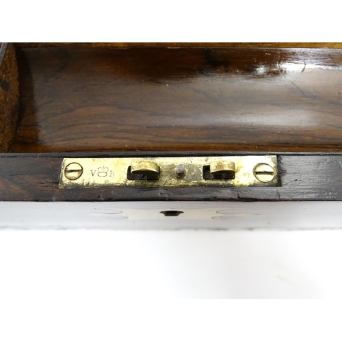 1553 - A Victorian writing slope with brass mounts, opening to reveal a fitted interior with two small conc... 