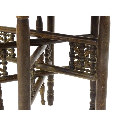 243 - An Islamic brass top table with a folding base. 25