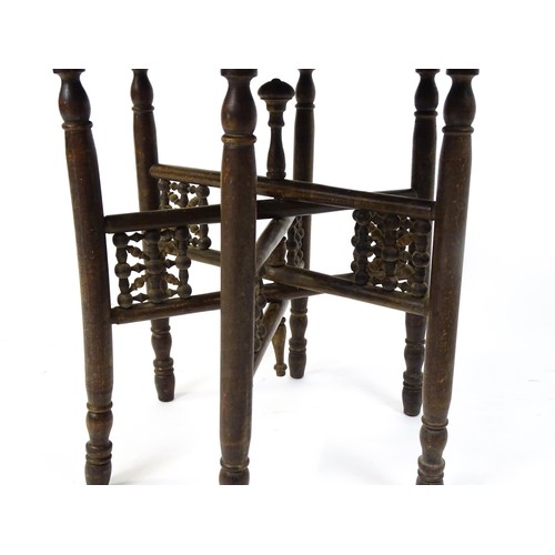 243 - An Islamic brass top table with a folding base. 25