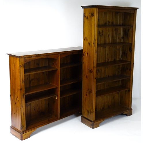 664 - Two modern pine bookcases with moulded cornices and raised on bracket feet. The tall bookcase 39