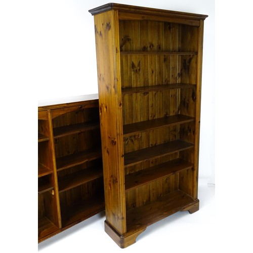 664 - Two modern pine bookcases with moulded cornices and raised on bracket feet. The tall bookcase 39