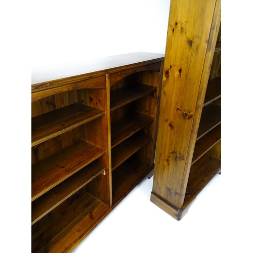 664 - Two modern pine bookcases with moulded cornices and raised on bracket feet. The tall bookcase 39