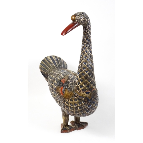 1576 - A very large 20thC carved wooden model of a goose with polychrome decoration. Approx. 50