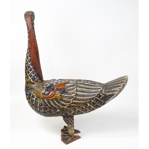 1576 - A very large 20thC carved wooden model of a goose with polychrome decoration. Approx. 50