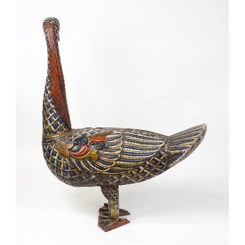 1576 - A very large 20thC carved wooden model of a goose with polychrome decoration. Approx. 50