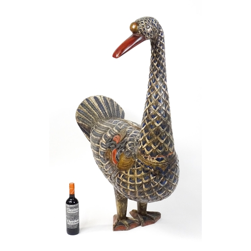 1576 - A very large 20thC carved wooden model of a goose with polychrome decoration. Approx. 50