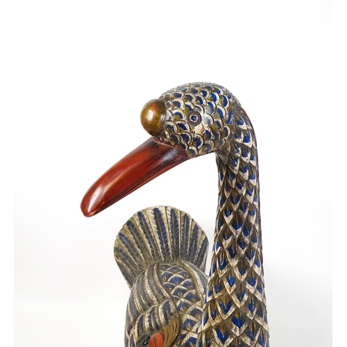 1576 - A very large 20thC carved wooden model of a goose with polychrome decoration. Approx. 50