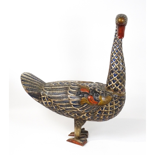 1576 - A very large 20thC carved wooden model of a goose with polychrome decoration. Approx. 50