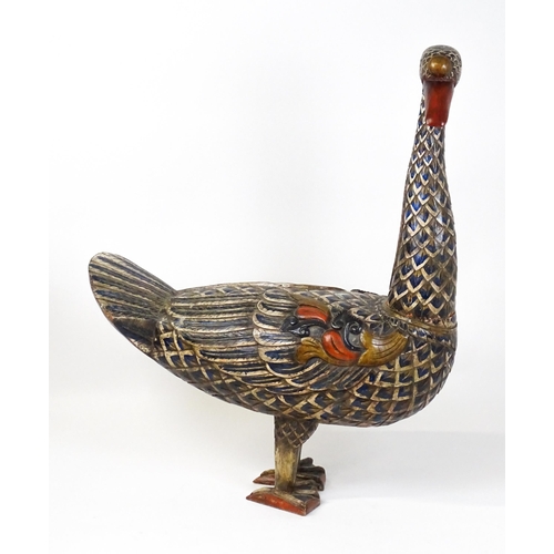 1576 - A very large 20thC carved wooden model of a goose with polychrome decoration. Approx. 50