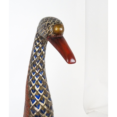 1576 - A very large 20thC carved wooden model of a goose with polychrome decoration. Approx. 50