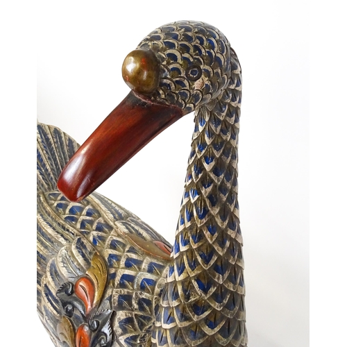 1576 - A very large 20thC carved wooden model of a goose with polychrome decoration. Approx. 50