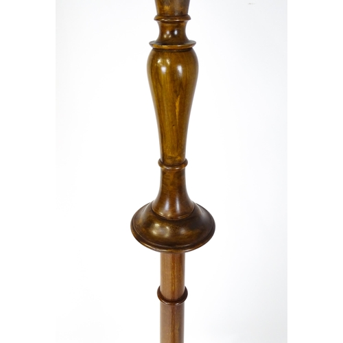 1683 - A turned wooden standard lamp raised on squat bun feet. Approx. 62