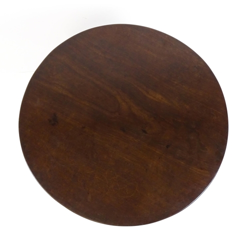 1710 - A Georgian mahogany tripod table with a one plank top above a turned pedestal base and raised on thr... 