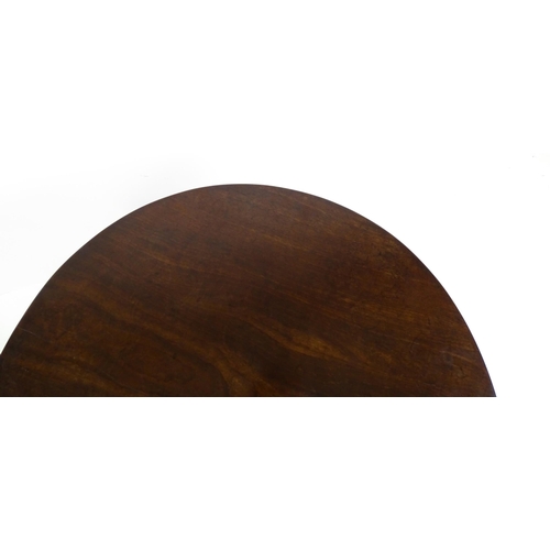 1710 - A Georgian mahogany tripod table with a one plank top above a turned pedestal base and raised on thr... 