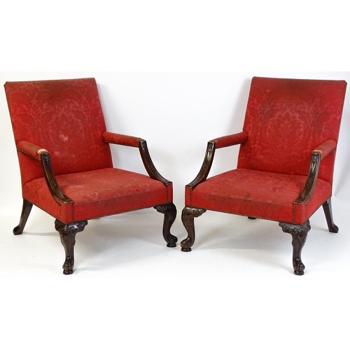 1714 - A pair of 19thC Gainsborough armchairs with carved arm raised on carved cabriole legs. 31