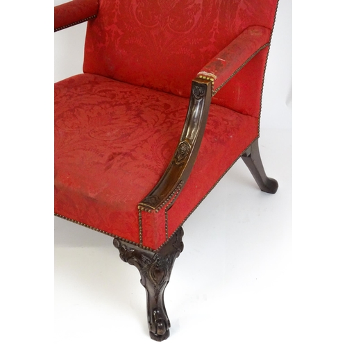 1714 - A pair of 19thC Gainsborough armchairs with carved arm raised on carved cabriole legs. 31