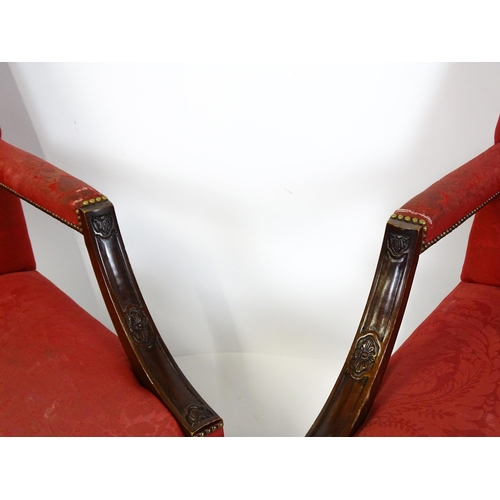 1714 - A pair of 19thC Gainsborough armchairs with carved arm raised on carved cabriole legs. 31