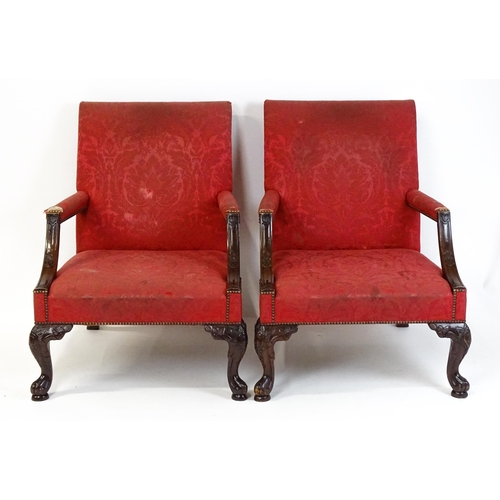 1714 - A pair of 19thC Gainsborough armchairs with carved arm raised on carved cabriole legs. 31