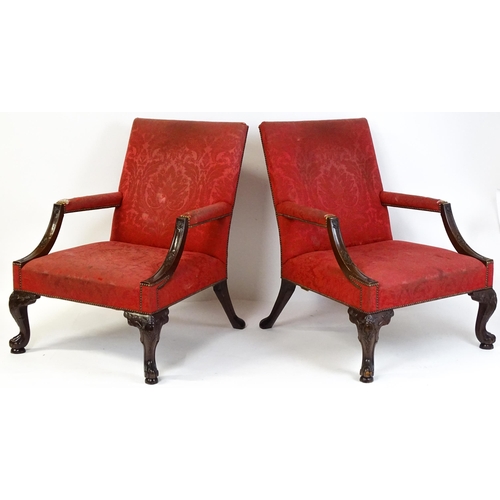 1714 - A pair of 19thC Gainsborough armchairs with carved arm raised on carved cabriole legs. 31