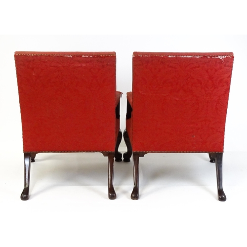 1714 - A pair of 19thC Gainsborough armchairs with carved arm raised on carved cabriole legs. 31