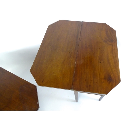 1716 - A pair of George III mahogany card tables with canted corners and raised on straight tapering legs. ... 