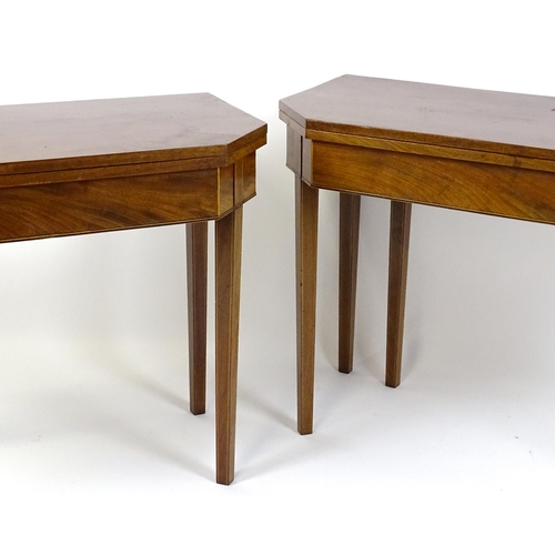 1716 - A pair of George III mahogany card tables with canted corners and raised on straight tapering legs. ... 