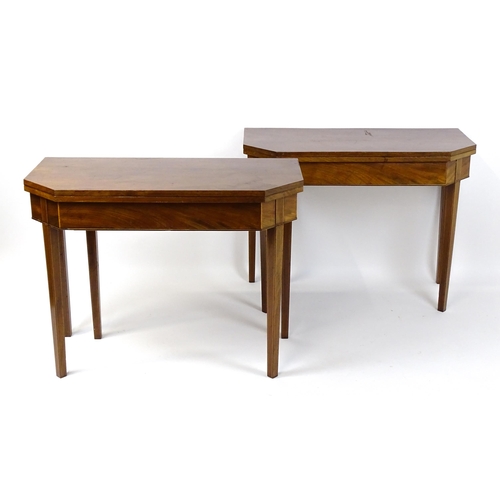 1716 - A pair of George III mahogany card tables with canted corners and raised on straight tapering legs. ... 