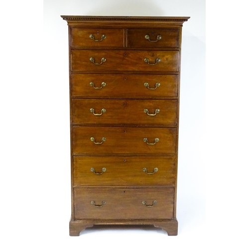 1718 - A Georgian mahogany tall boy / chest of drawers with a moulded cornice above a dentil carved frieze ... 