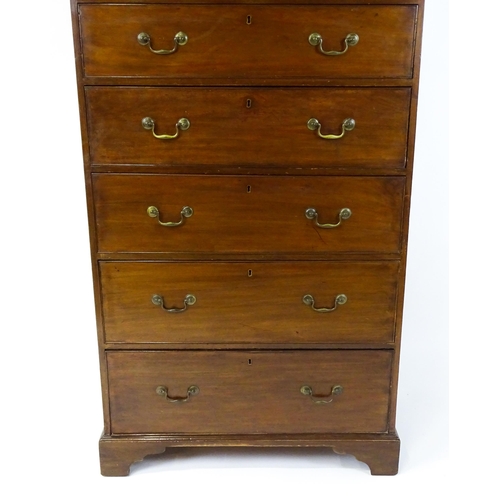 1718 - A Georgian mahogany tall boy / chest of drawers with a moulded cornice above a dentil carved frieze ... 