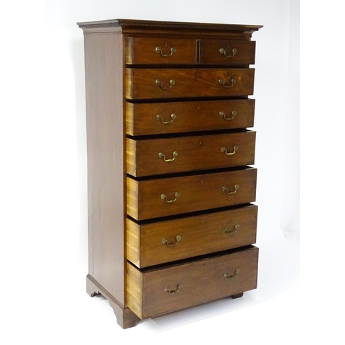 1718 - A Georgian mahogany tall boy / chest of drawers with a moulded cornice above a dentil carved frieze ... 