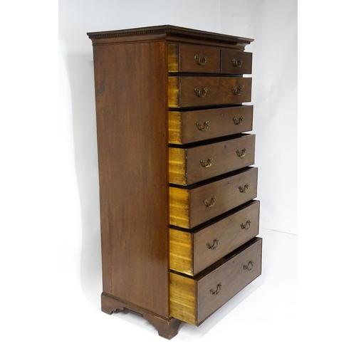 1718 - A Georgian mahogany tall boy / chest of drawers with a moulded cornice above a dentil carved frieze ... 