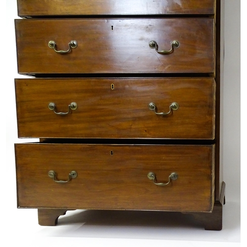 1718 - A Georgian mahogany tall boy / chest of drawers with a moulded cornice above a dentil carved frieze ... 