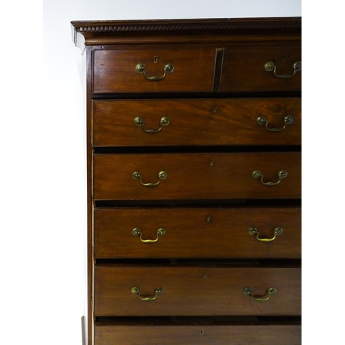 1718 - A Georgian mahogany tall boy / chest of drawers with a moulded cornice above a dentil carved frieze ... 