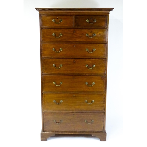 1718 - A Georgian mahogany tall boy / chest of drawers with a moulded cornice above a dentil carved frieze ... 