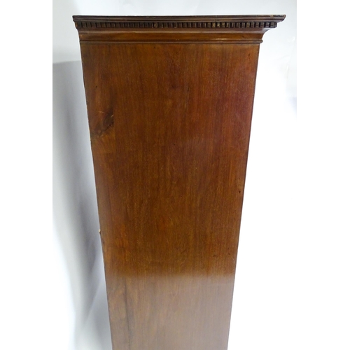 1718 - A Georgian mahogany tall boy / chest of drawers with a moulded cornice above a dentil carved frieze ... 