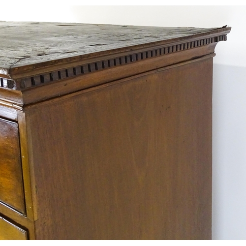 1718 - A Georgian mahogany tall boy / chest of drawers with a moulded cornice above a dentil carved frieze ... 