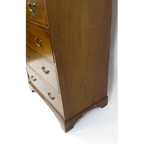 1718 - A Georgian mahogany tall boy / chest of drawers with a moulded cornice above a dentil carved frieze ... 