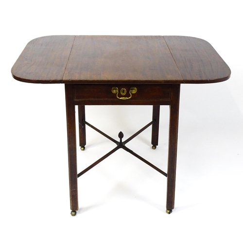 1733 - A Georgian mahogany drop flap table with two rounded leaves above a single frieze drawer with brass ... 