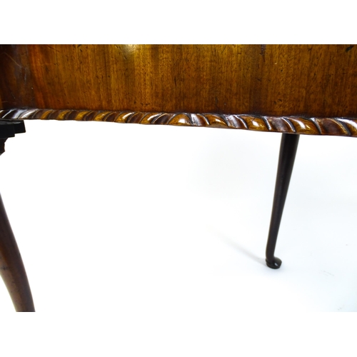 1734 - An 18thC Chippendale style card table with a hinged, inverted breakfront top above carved cabriole f... 