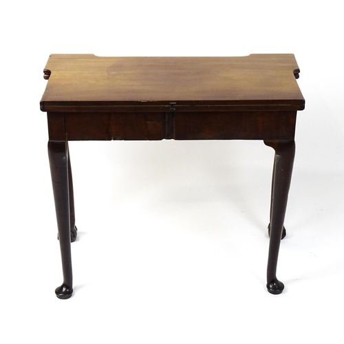 1734 - An 18thC Chippendale style card table with a hinged, inverted breakfront top above carved cabriole f... 