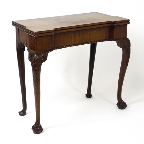 1734 - An 18thC Chippendale style card table with a hinged, inverted breakfront top above carved cabriole f... 