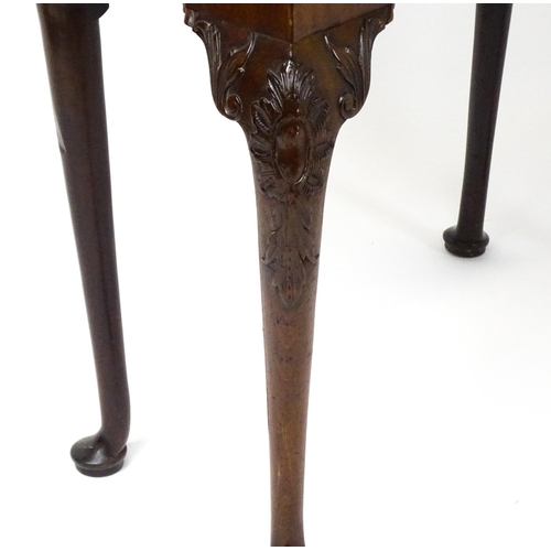 1734 - An 18thC Chippendale style card table with a hinged, inverted breakfront top above carved cabriole f... 