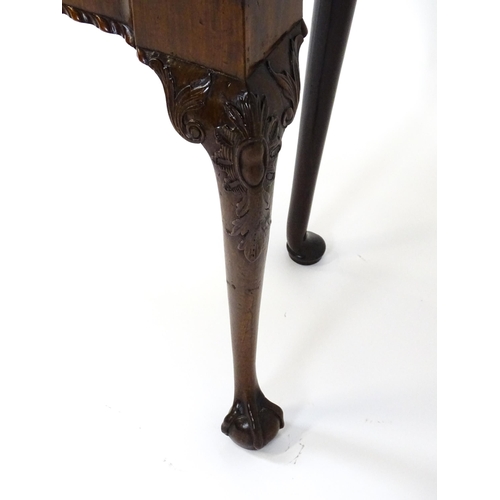 1734 - An 18thC Chippendale style card table with a hinged, inverted breakfront top above carved cabriole f... 