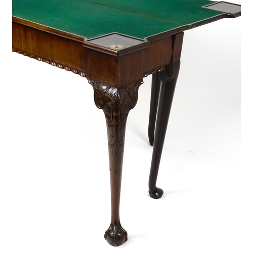 1734 - An 18thC Chippendale style card table with a hinged, inverted breakfront top above carved cabriole f... 