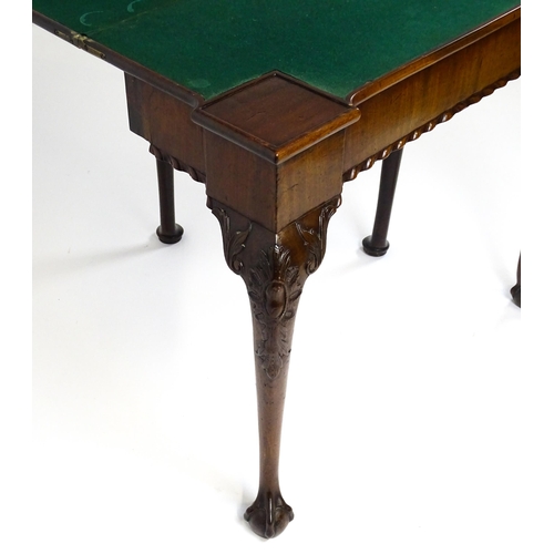 1734 - An 18thC Chippendale style card table with a hinged, inverted breakfront top above carved cabriole f... 