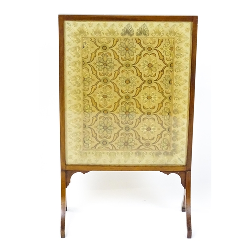 1737 - A late 19thC needlework fire screen raised on four shaped legs. 23