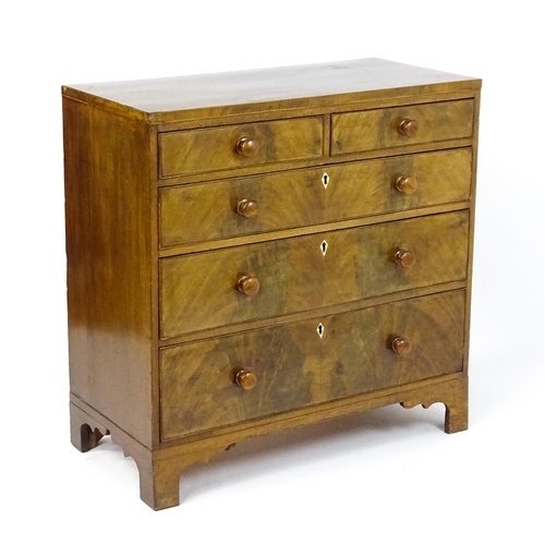 1740 - A Georgian mahogany chest of drawers with two short drawers over three long drawers with diamond sha... 